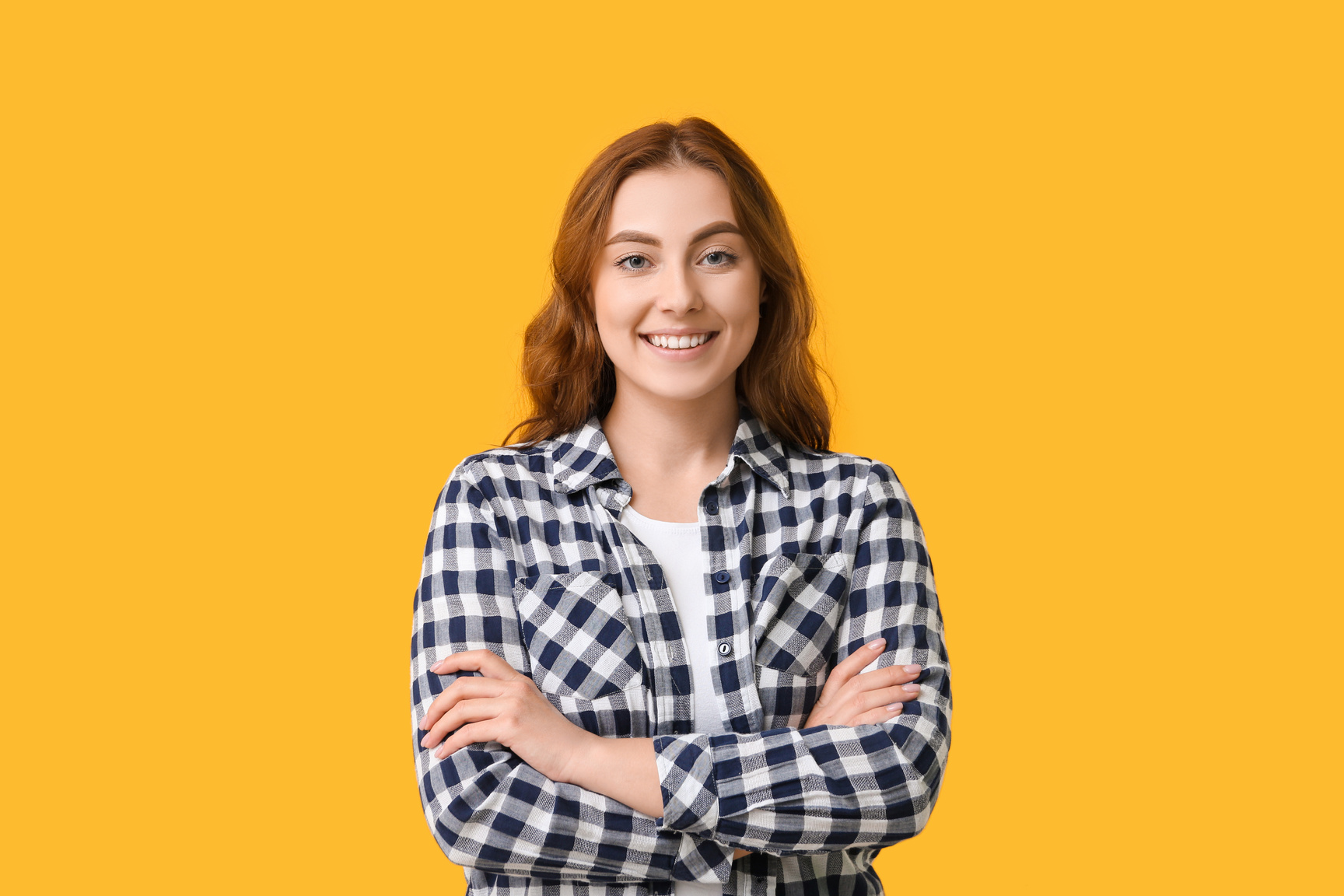 Photo of a Young Woman Smiling on a Bright Background