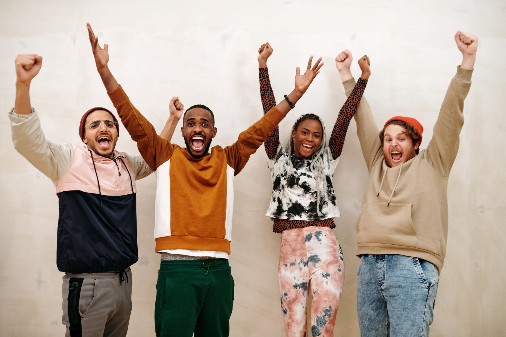 Multiracial People with Hands Raised 